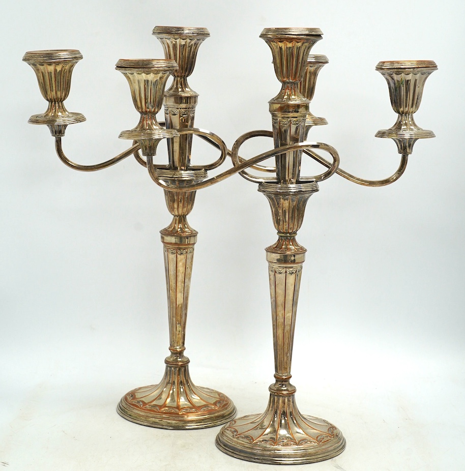 A pair of 19th century Old Sheffield plate three light, two branch candelabra, 44cm high. Condition - fair to good